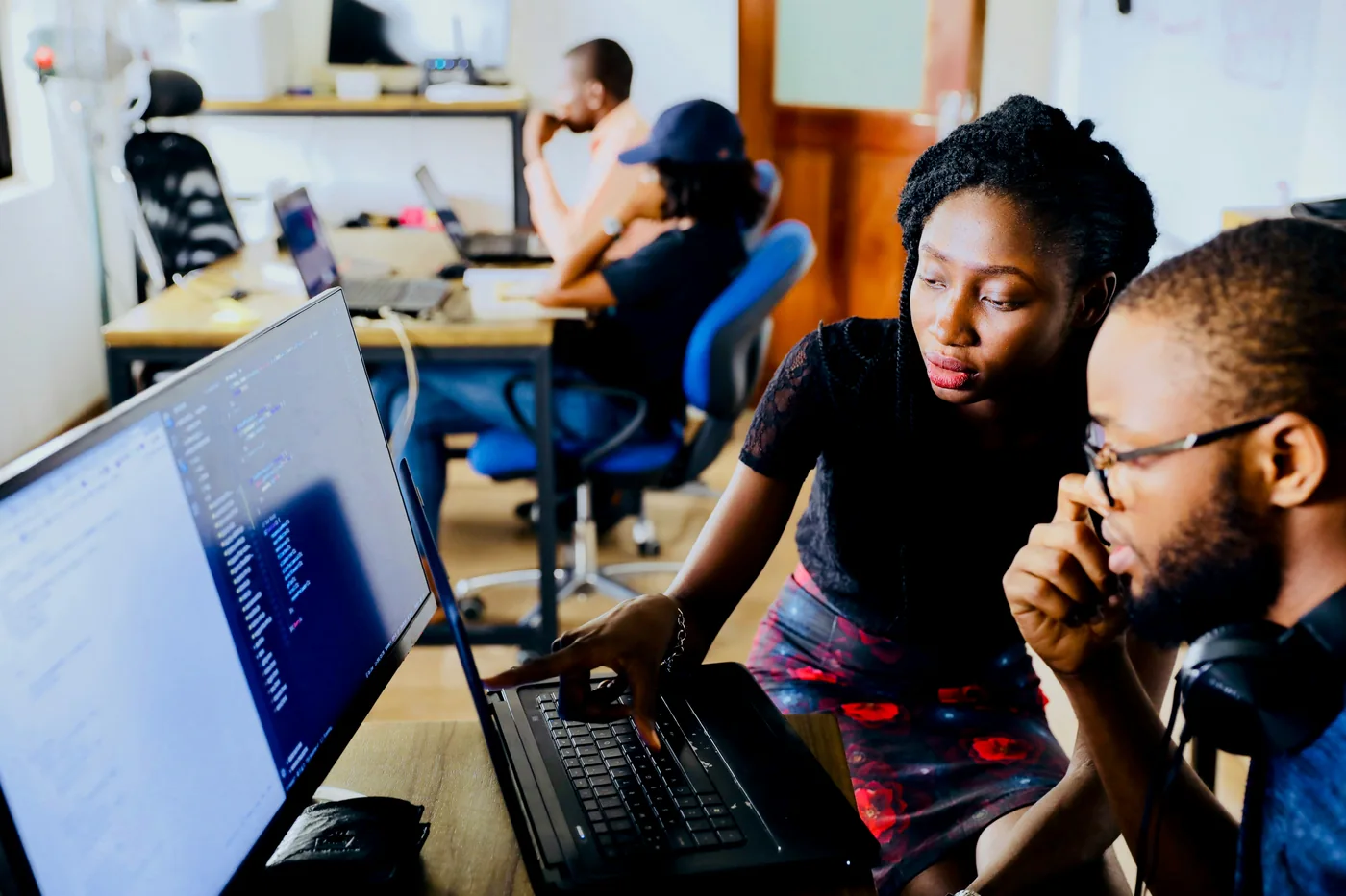 Two adults working together at a computer