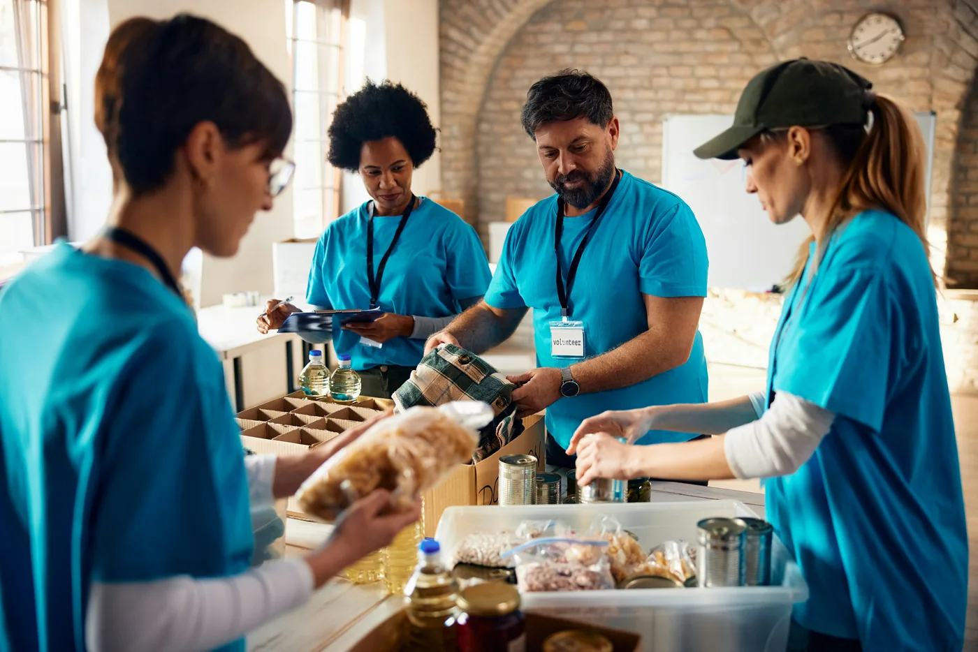 People sorting groceries into donation boxes