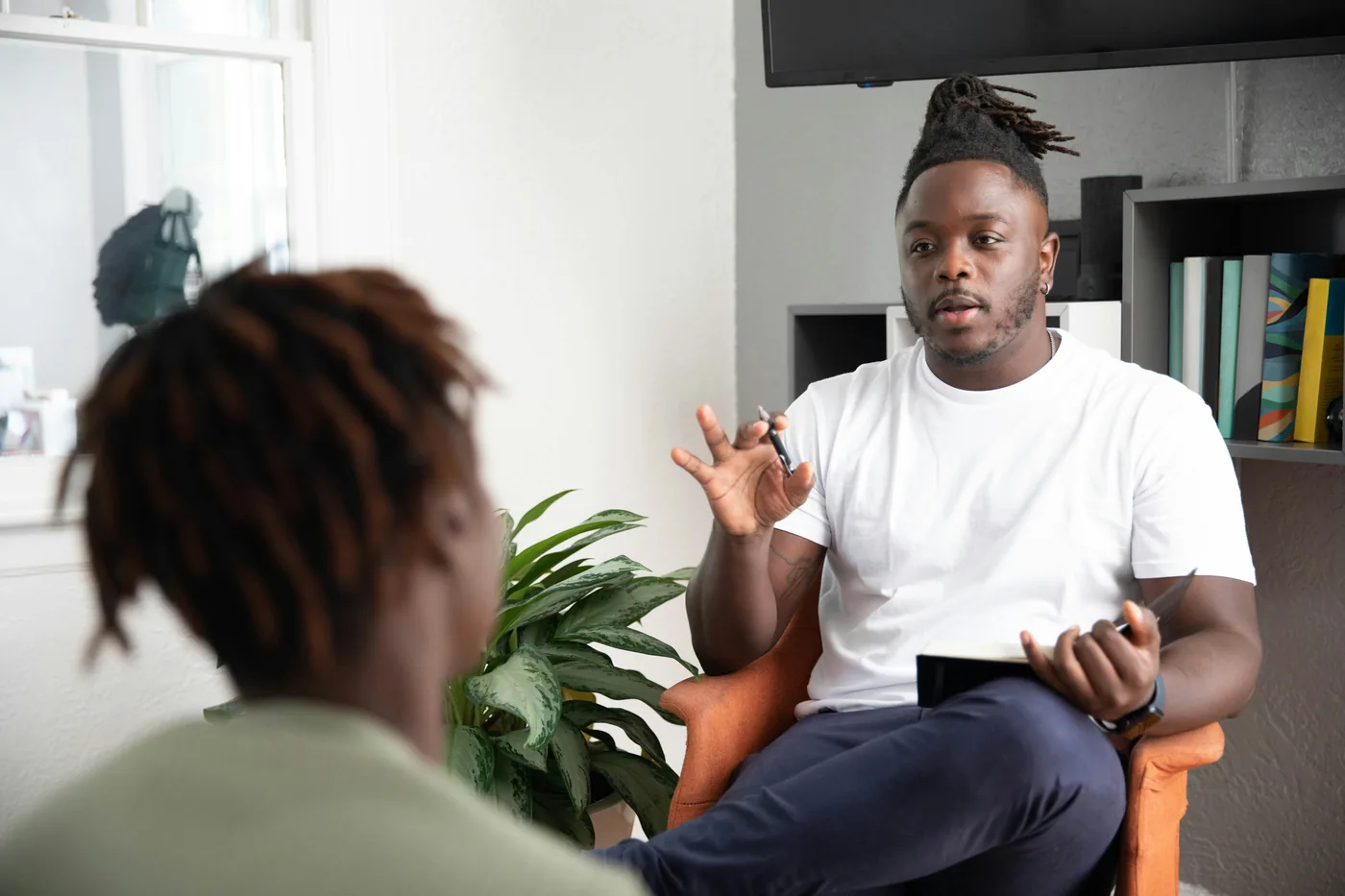 Two adults talking in a seated conversation