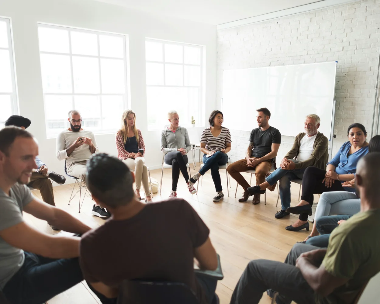 Adults sitting together in a discussion circle