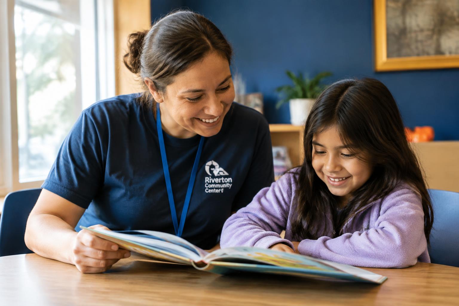 A volunteer mentor reading with a young student